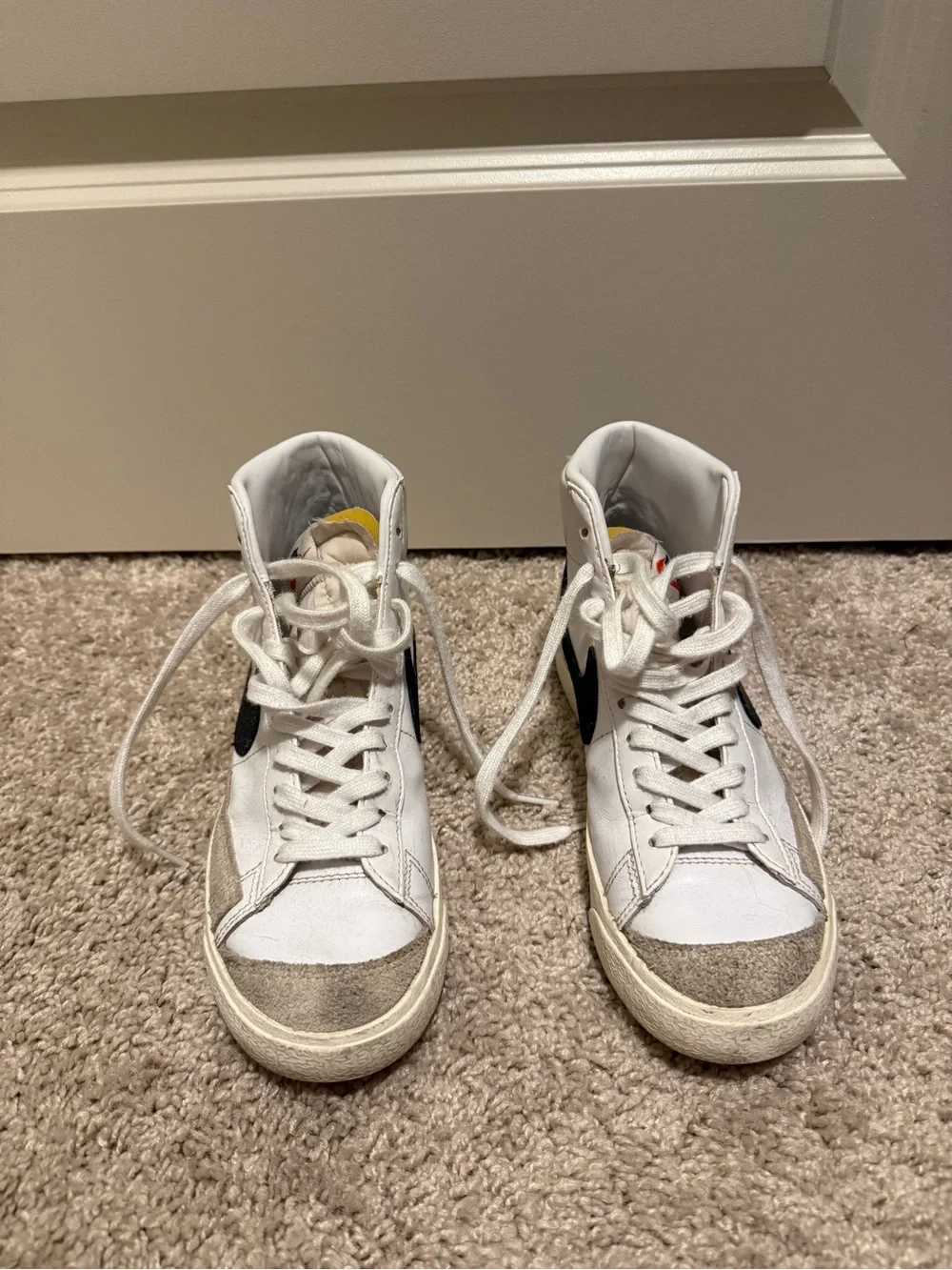 Nike White High-Top Sneakers with Black Swoosh